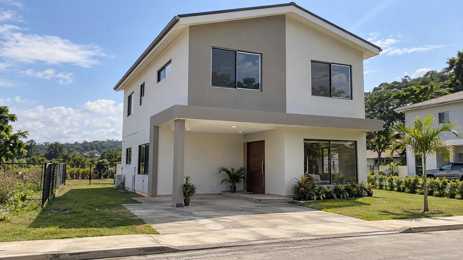 Casa de dos pisos en steel framing terminada, con fachada lisa en blanco y gris, ventanería y cubierta metálica